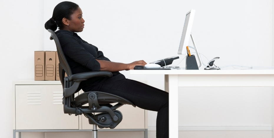 A person sitting at a desk with bad posture