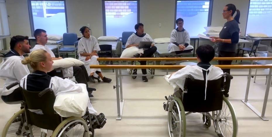 Physiotherapy students participate in a peer simulation training session