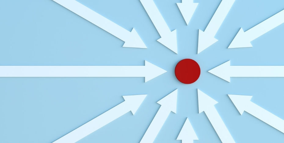 A red dot in the middle of white arrows.