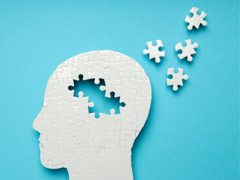 Blue background puzzle of a person's head with parts missing