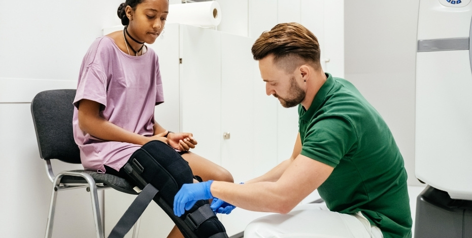 Physiotherapist working with a patient wearing a leg brace