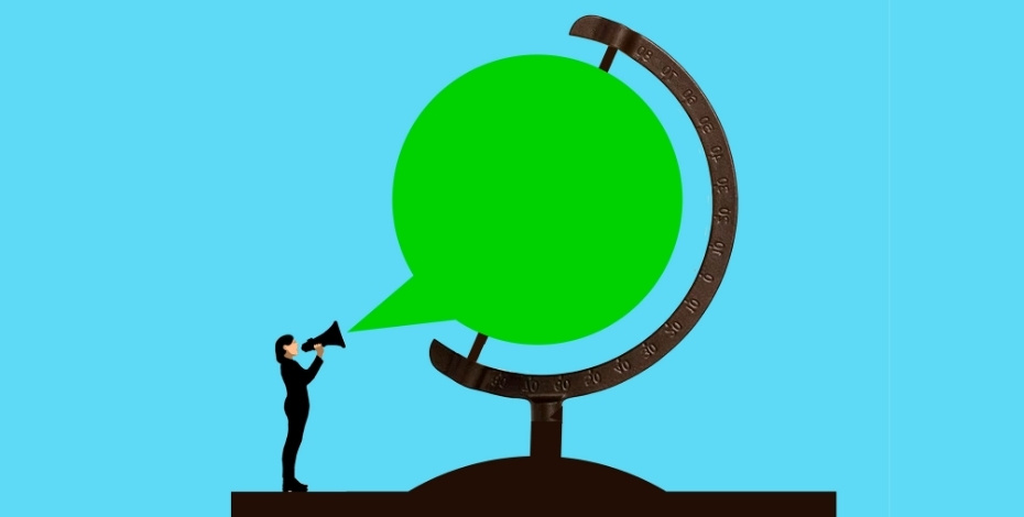 A woman speaking into a speech bubble shaped like a globe. 