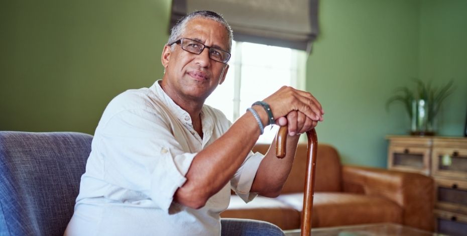 A cancer patient sits at home waiting for his physiotherapist to arrive, as it is a mobile service.,
