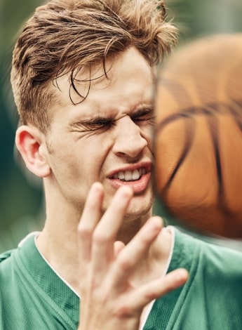 Basketball hitting a persons face