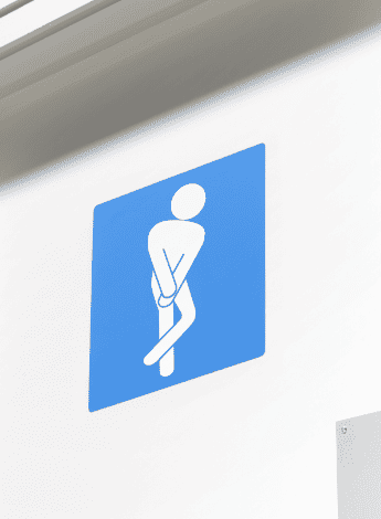 Altered graphic of a male toilet sign with figure crossing his legs in pain