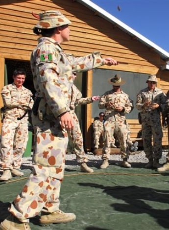 Australian Army officer Major Emma Williams playing two-up on Anzac Day in Afghanistan.