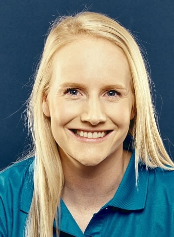 The image is of a woman with long blonde hair, wearing a teal blue polo shirt. 
