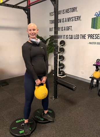 Cancer patient Madolyn Ryan holding gym equipment