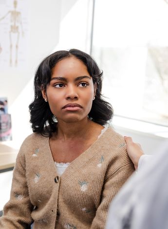 A person being comforted in a medical appointment