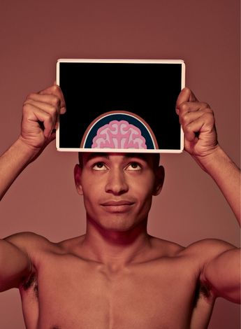 A man holding up a graphic of the brain over his head