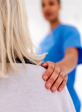 A person being comforted in a medical appointment