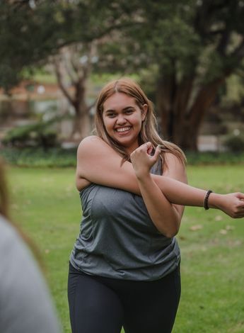 A person smiling and stretching