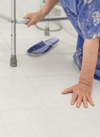 "older person on the floor having fallen"