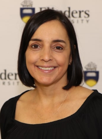 A headshot of physiotherapist Dr Tamina Levy against a 'Flinders University' background.